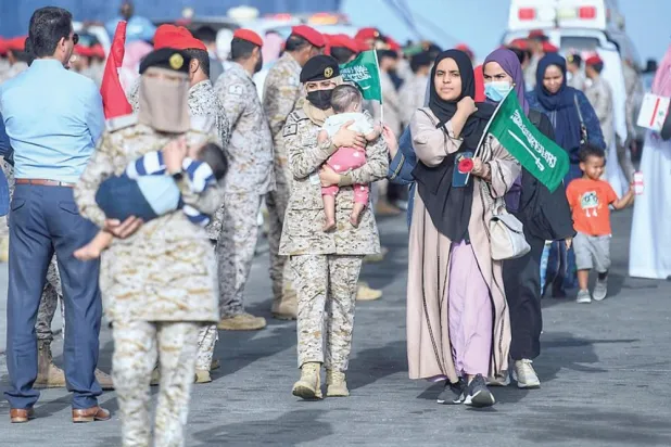 Evacuees from Sudan are welcomed at Jeddah port. (dpa) 