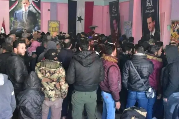 Individuals at the reconciliation center in Daraa Al-Mahatta city, Syria (an image circulated on social media platforms)