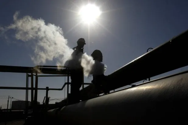 Caption: FILE - In this Feb. 26, 2011 file photo, a Libyan oil worker, works at a refinery inside the Brega oil complex, in Brega, eastern Libya. (AP Photo/Hussein Malla, File)