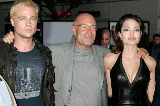 قطب هوليوود أرنون ميلشان يتوسط نجمي هوليوود براد بيت وأنجيلينا جولي (رويترز)