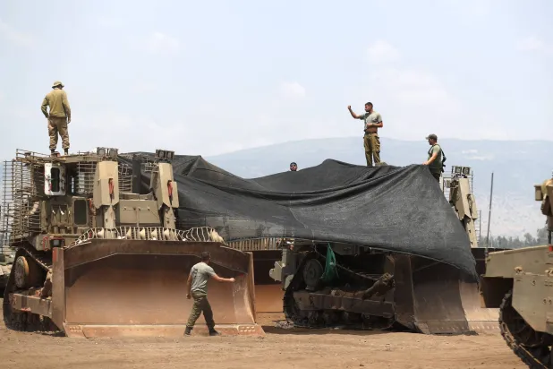 جنود إسرائيليون في موقع تجمع بوادي الحولة في الجليل قرب الحدود الإسرائيلية اللبنانية قبل مناورة كبيرة الاثنين (إ.ب.أ)