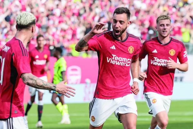 برونو فيرنانديز (في الوسط) يحتفل بتسجيل هدف يونايتد الاول في مرمى ارسنال بالجولة الاميركية (ا ب ا)