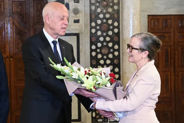 epa10782071 A  handout photo made available by the Tunisian Presidency's official shows Tunisian President Kais Saied offering flowers to outgoing Prime Minister Najla Bouden during a handover ceremony at the Kasbah Palace in Tunis, Tunisia on 02 August 2023. Tunisian President Kaïs Saïed has decided to 'terminate the functions' of Prime Minister Najla Bouden, the first woman to lead a government in Tunisia, on the evening of 01 August . He immediately appointed in her place Ahmed Hachani, who until now worked at the Central Bank of Tunisia and studied at the Faculty of Law of the University of Tunis where Kaïs Saïed taught.  EPA/Tunisian Presidency HANDOUT  HANDOUT EDITORIAL USE ONLY/NO SALES