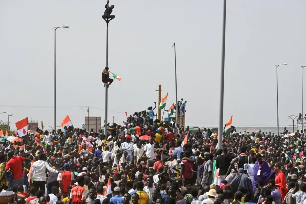 أنصار المجلس العسكري يتظاهرون خارج مقر القاعدة العسكرية الفرنسية في نيامي (أ.ف.ب)