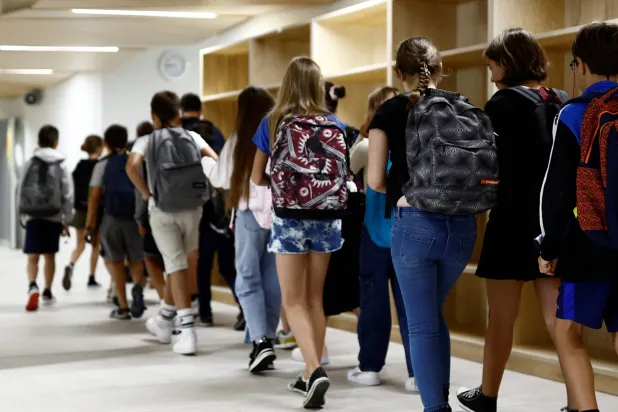 طلاب وصلوا المدرسة في اليوم الأول من العام الدراسي الجديد بعد العطلة الصيفية في مدرسة أنطوان دو سانت إكزوبيري المتوسطة في سافيناي بفرنسا في 4 سبتمبر 2023 (رويترز)