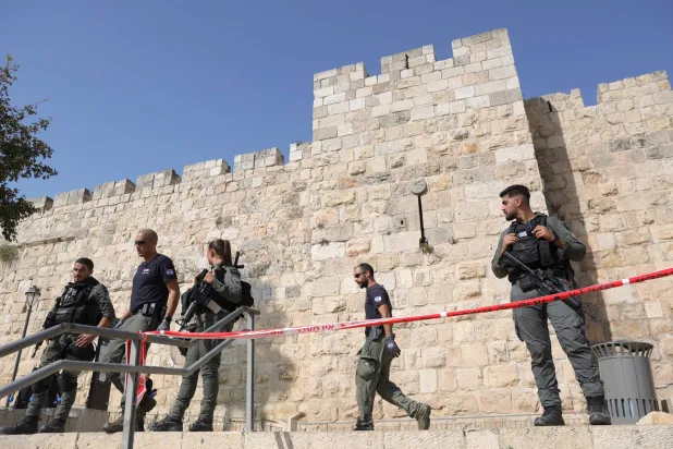 ضباط شرطة إسرائيليون مسلحون يراقبون خلف طوق أمني في مكان هجوم الطعن بالقرب من باب الخليل في البلدة القديمة بالقدس الأربعاء 6 سبتمبر 2023 (إ.ب.أ)