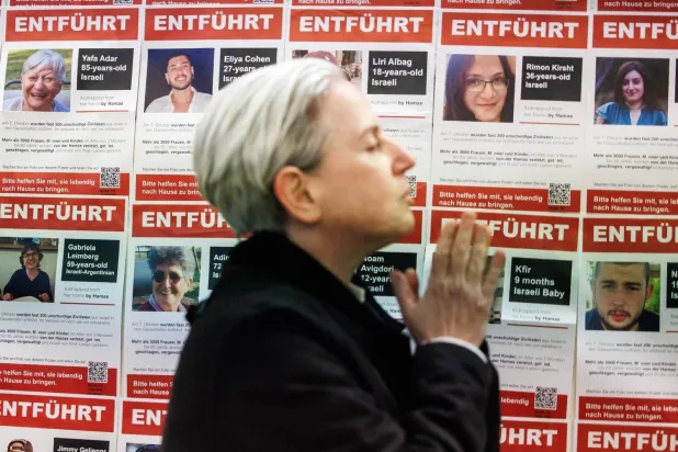 Pictures of prisoners held by Hamas on the wall of a synagogue in Berlin on Friday (EPA)

