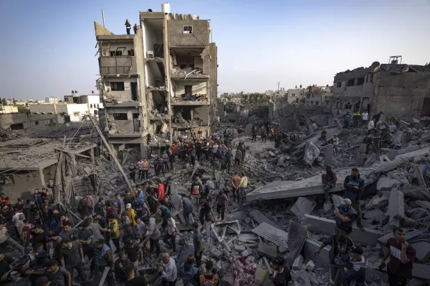 Residents searching for survivors after the Israeli bombing in the Maghazi refugee camp in the Gaza Strip on Sunday (AP)
