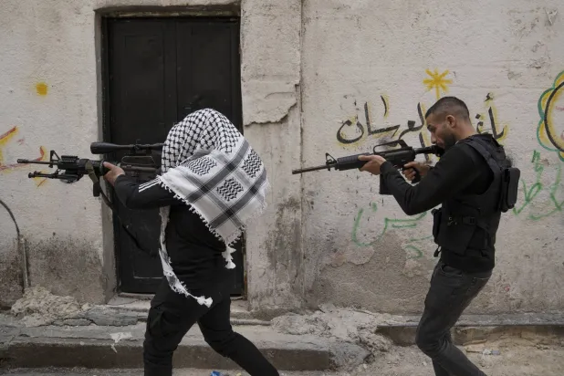 عرض عسكري لـ«شهداء الأقصى» الجناح العسكري لـ«فتح» خلال تأبين في مخيم بلاطة بالضفة 5 مايو الماضي (أ.ف.ب)