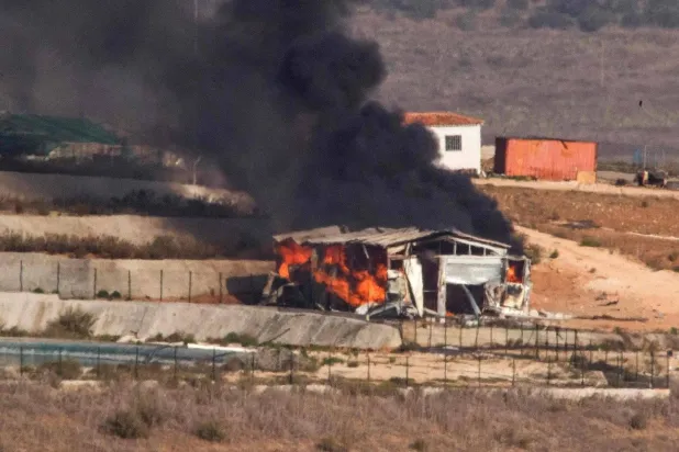 Flames and smoke rise from an agricultural structure in southern Lebanon's Khiam plain following Israeli bombardment on November 23, 2023. (Photo by HASSAN FNEICH / AFP)