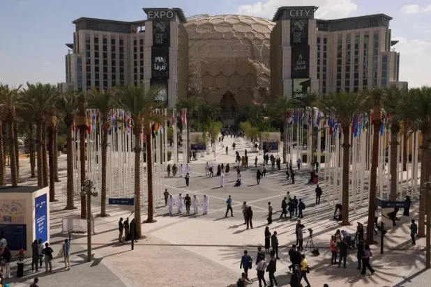 People arrive at the venue of the COP28 United Nations climate summit in Dubai on November 30, 2023. The UN climate conference opens in Dubai on November 30 with nations under pressure to increase the urgency of action on global warming. (Photo by KARIM SAHIB / AFP)