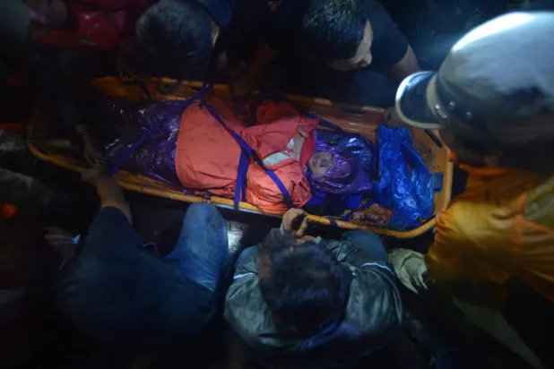 فريق إنقاذ إندونيسي يقوم بإجلاء ضحية ثوران بركان جبل مارابي  (رويترز)