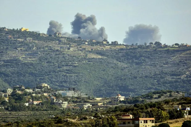 An Israeli raid on a site in South Lebanon between the towns of Rmeish and Ramiya (AFP)