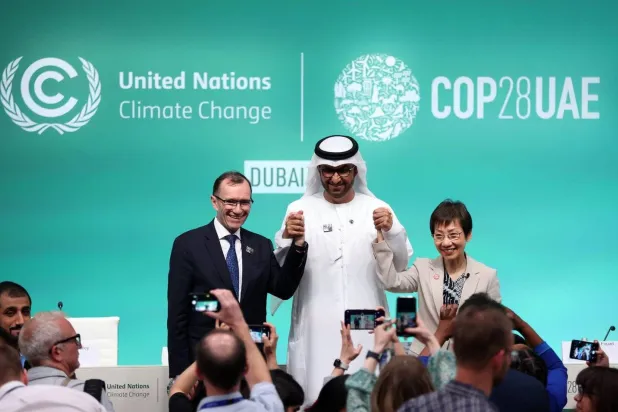 Sultan Al Jaber, President of COP28, alongside the Singaporean Minister of Environment and the Norwegian Minister of Environment in a press conference on Friday (AP)