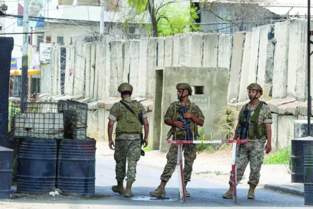 Lebanese soldiers at the entrance to the Ain al-Hilweh camp in southern Lebanon during clashes last summer between Palestinian factions (AFP)