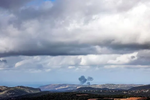  Smoke billows across the horizon along the hills in the Naqoura area of southern Lebanon following Israeli bombardment from a position along the border in northern Israel on December 24, 2023. (AFP)