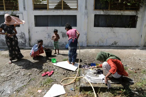 لاجئون من الروهينغا في مأواهم المؤقت إلى جانب الطابق الأرضي من مبنى حكومي في باندا آتشيه - إندونيسيا (إ.ب.أ)