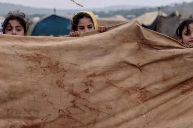 Children are seen at a refugee camp in Syria's Idlib on January 14. (EPA)