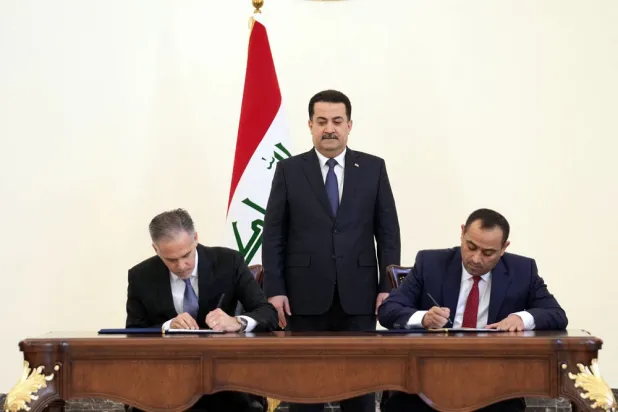 This handout photo released by the Iraqi prime minister's press office shows premier Mohammed Shia al-Sudani (C) overseeing the signing of a Memorandum of Understanding between Iraq's Electricity Authority and the the US General Electric company in Baghdad on February 16, 2023. (Iraqi Prime Minister's Press Office / AFP)