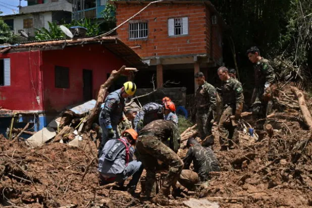 رجال إنقاذ في منطقة متضررة من الفيضانات (ا.ف.ب)