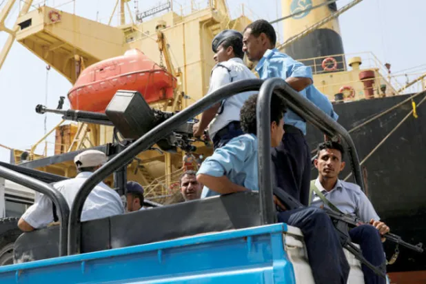 حوثيون يستقلون مركبة عسكرية في ميناء الحديدة الخاضع لهم غرب اليمن (رويترز)