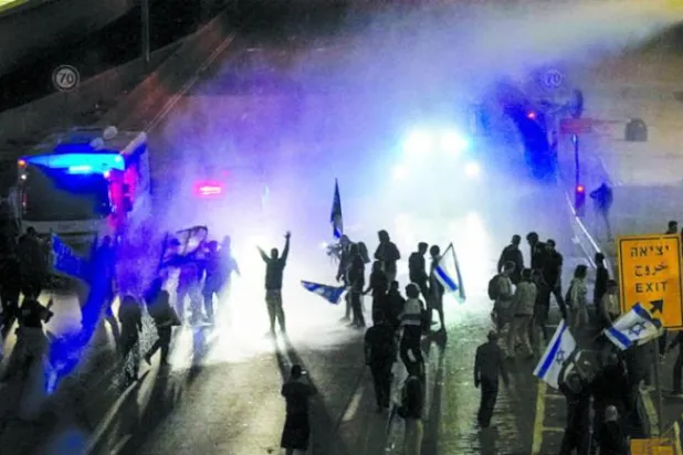 اسرائیلی پولیس ہفتے کے روز تل ابیب میں مظاہرین کو منتشر کرنے کے لیے پانی کا استعمال کر رہی ہے (اے پی)