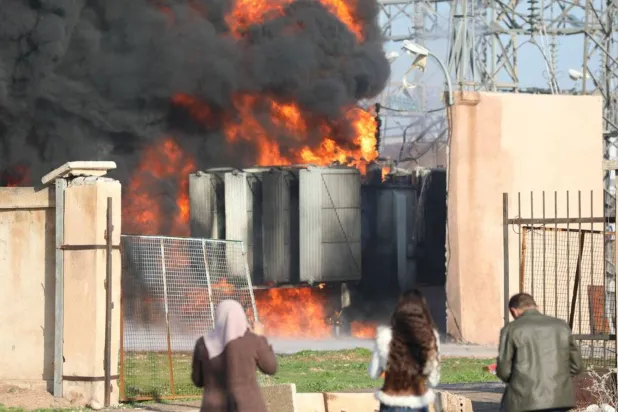 Flames rising from the power station in Qamishli on Monday after a Turkish bombing (EPA)