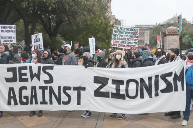 Jewish protesters in Austin carry a banner against Zionism (EPA)