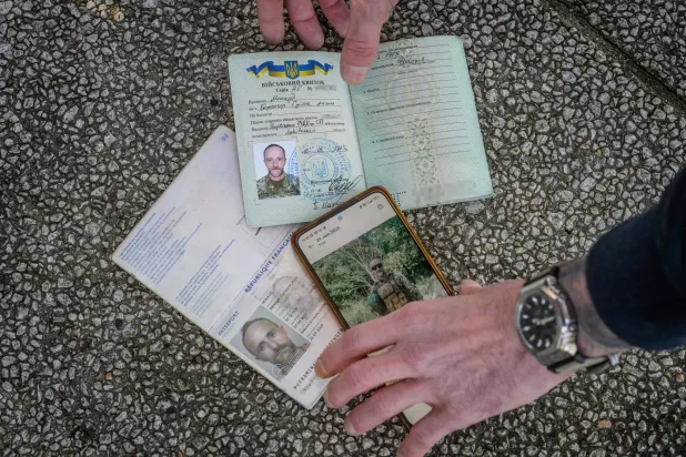 بيرانجيه مينو الذي قاتل في صفوف الجيش الأوكراني يعرض جواز فسره الفرنسي وهويته العسكرية الأوكرانية... وتقول موسكو إنه قتل في خاركيف