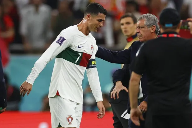 Soccer Football - FIFA World Cup Qatar 2022 - Quarter Final - Morocco v Portugal - Al Thumama Stadium, Doha, Qatar - December 10, 2022 Portugal's Cristiano Ronaldo and coach Fernando Santos look dejected after the match as Portugal are eliminated from the World Cup REUTERS/Kai Pfaffenbach