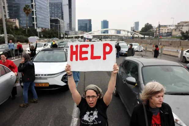 An Israeli woman participates in a march demanding the expedited release of hostages held by Hamas in Tel Aviv on Friday (Reuters)