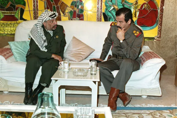 Saddam Hussein during a meeting with Yasser Arafat in Baghdad in May 1990 (Getty Images)