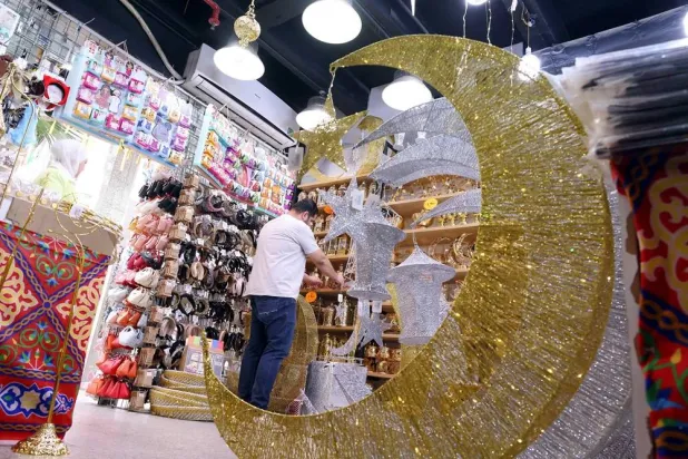  A vendor arranges decorative items in his shop at a market in Kuwait City on March 10, 2024, ahead of the Muslim holy fasting month of Ramadan. (AFP) 