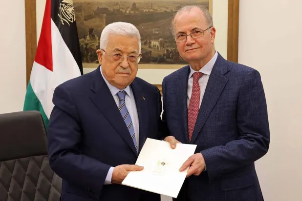 This handout picture provided by the Palestinian Authority's Press Office (PPO) shows Palestinian President Mahmud Abbas (L) posing with the newly appointed Palestinian Prime Minister Mohammad Mustafa, in Ramallah on March 14, 2024. (Photo by PPO / AFP / Handout) 