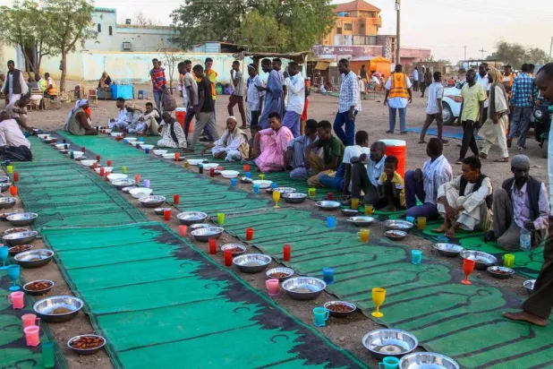 Internally displaced Muslim devotees wait to break their fast at a courtyard during the Muslim holy month of Ramadan in Gedaref on March 13, 2024. (AFP)