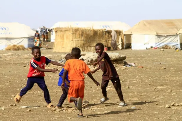 Displaced Sudanese children play near tents at a camp in southern Gadaref state for people who fled Khartoum and Jazira states, in war-torn Sudan, on March 20, 2024. (AFP)