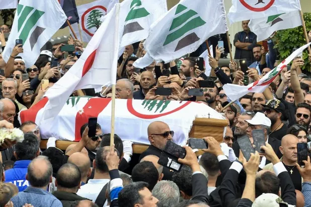 Mourners carry the coffin of Pascal Sleiman, an official of the Lebanese Forces party, during his funeral in Jbeil, Lebanon, 12 April 2024. (EPA) 