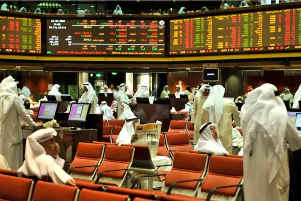 مستثمرون يتابعون تحركات الأسهم والسندات في صالة تداول ببورصة الكويت (رويترز)