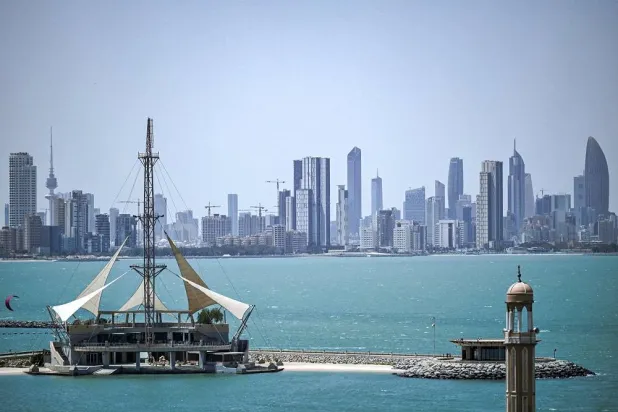 This picture taken on April 23, 2024 from Salmiya shows a view of an aquatics sports center with the skyline of Kuwait City behind. (AFP)