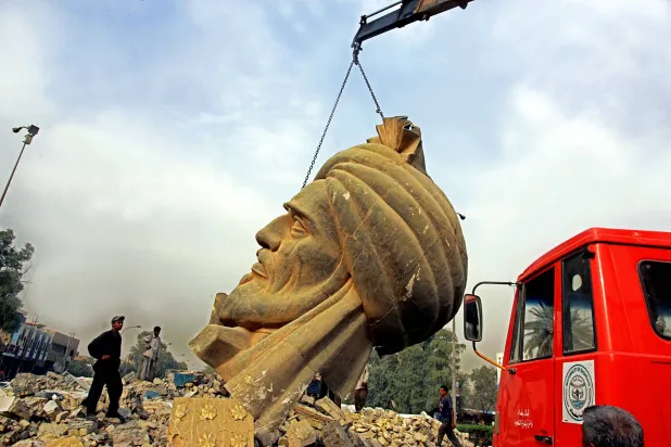 رافعة تنتشل رأس تمثال أبو جعفر المنصور من موقع انفجار استهدفه عام 2005 (أ.ف.ب)