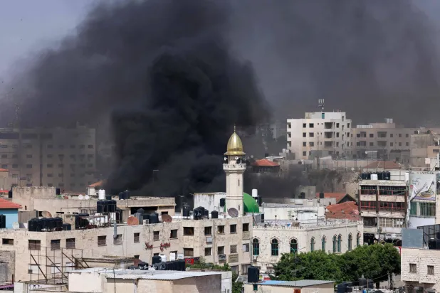الدخان يتصاعد في جنين خلال هجوم الجيش الإسرائيلي الثلاثاء (أ.ف.ب)