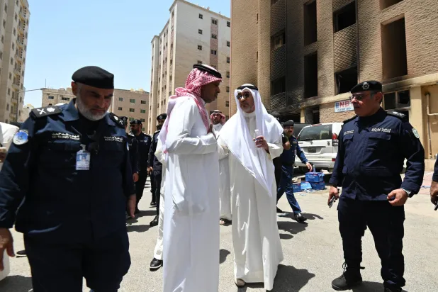 Kuwaiti First Deputy Prime Minister, Minister of Defense and Minister of Interior Sheikh Fahad Yusuf Al-Sabah (C-R) visits the site of a residential building after a fire broke out in Mangaf area, southern Ahmadi governorate, Kuwait, 12 June 2024. EPA/NOUFAL IBRAHIM