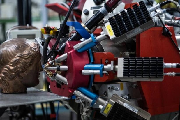 A bronze statue is tested with the center particle accelerator. JULIEN DE ROSA / AFP

