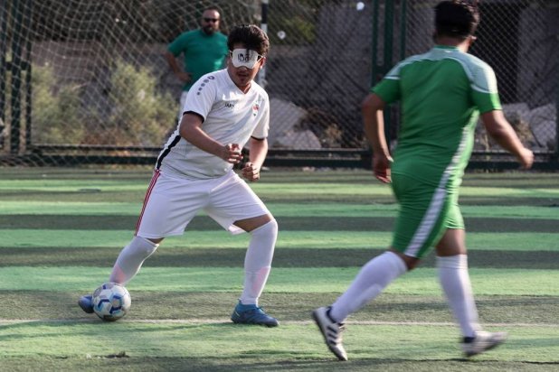 Members of Iraq's first national football team for the visually impaired, train at a sports club in Baghdad on May 22, 2024. (AFP)