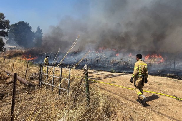 Israeli firefighters work following rocket attacks from Lebanon, amid ongoing cross-border hostilities between Hezbollah and Israeli forces, near the border on its Israeli side, June 13, 2024. REUTERS/Avi Ohayon 