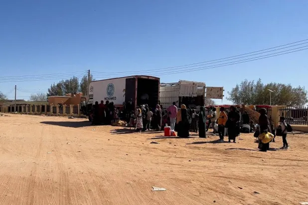 Sudanese families prepare to ride on trucks while on their way to Egypt through the Qustul border, after the crisis in Sudan's capital Khartoum, in the Sudanese city of Wadi Halfa, Sudan May 1, 2023. (Reuters)