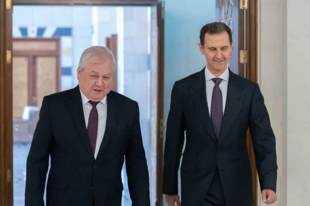 A handout picture released by the official Syrian Arab News Agency (SANA) shows Syrian President Bashar Assad receiving Russia's Special Envoy for Syria Alexander Lavrentiev in the capital Damascus (SANA/AFP)