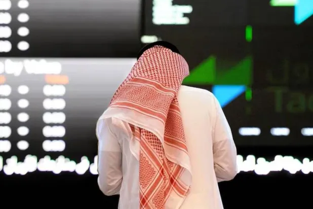 A man monitors the movement of stocks on the Saudi Tadawul index. (AFP) 