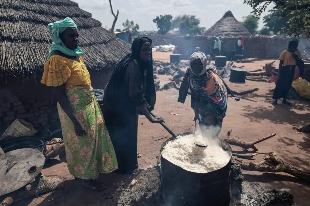 Volunteers prepare food for displaced people from Sudan in Chad on Wednesday. (Reuters) 