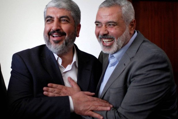 Hamas chief Khaled Meshaal hugs senior Hamas leader Ismail Haniyeh before leaving Gaza Strip December 10, 2012. REUTERS/Ahmed Jadallah/File
